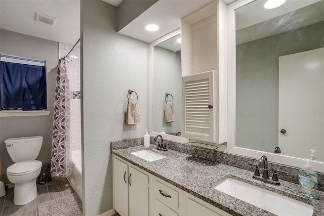 full bathroom with vanity, shower / bath combination with curtain, and toilet