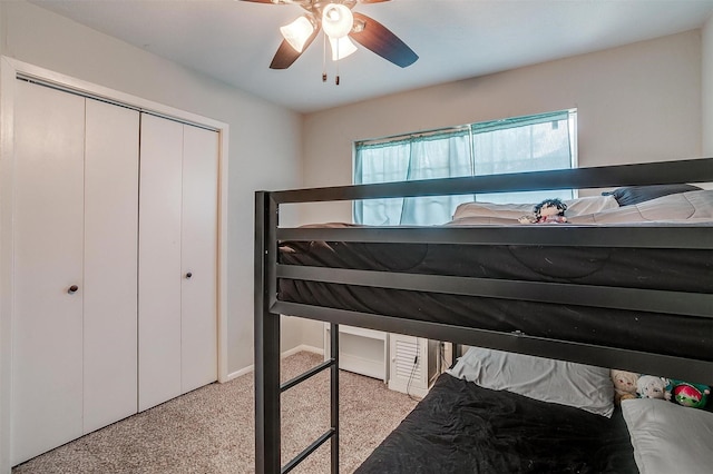 carpeted bedroom featuring a closet and ceiling fan