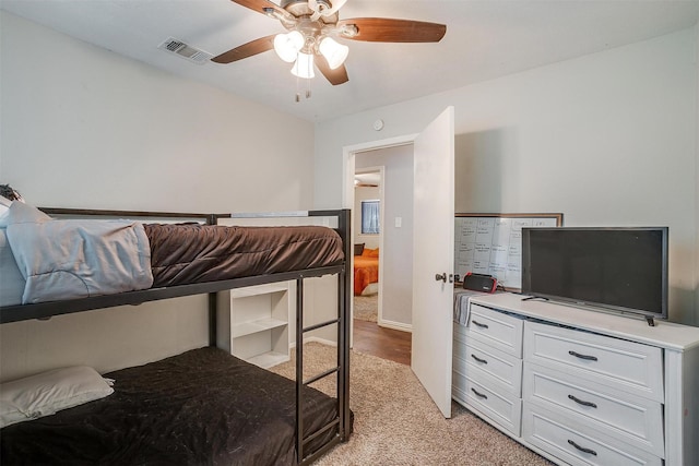 bedroom with ceiling fan and light carpet