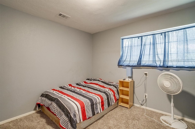 carpeted bedroom with a textured ceiling