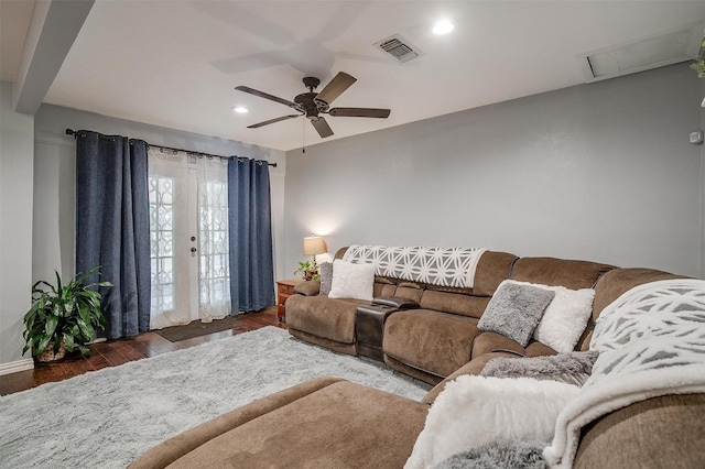 living room featuring ceiling fan and dark hardwood / wood-style floors