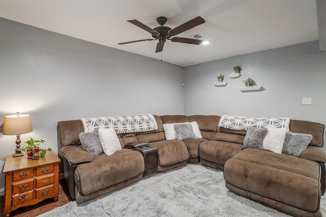 living room featuring hardwood / wood-style floors and ceiling fan