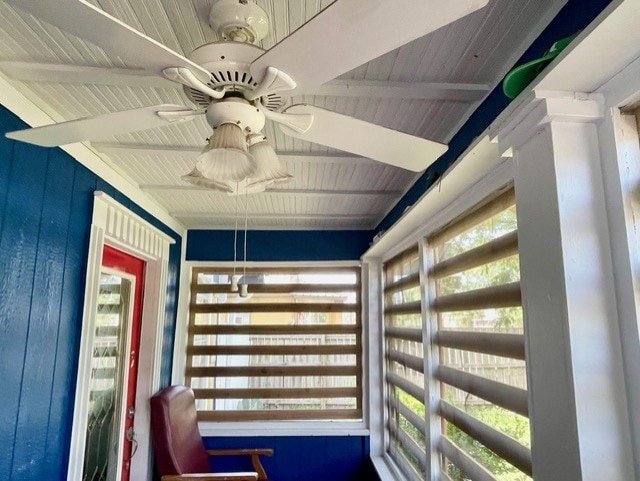 interior space with beamed ceiling, wooden ceiling, and ceiling fan