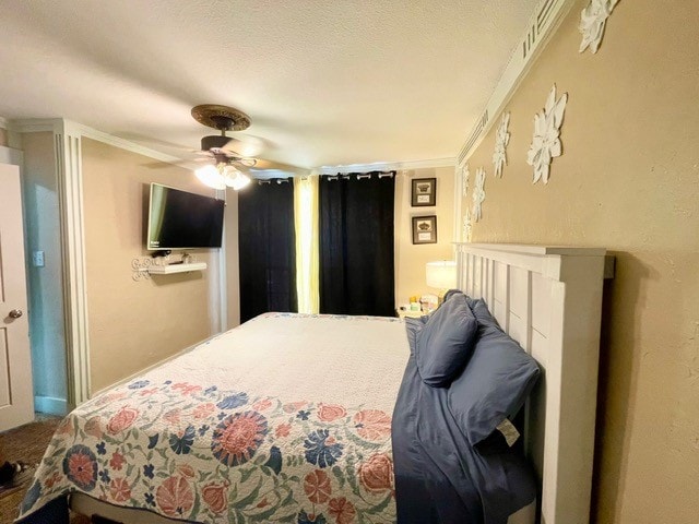 bedroom featuring ornamental molding and ceiling fan