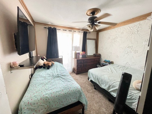 carpeted bedroom with ornamental molding and ceiling fan