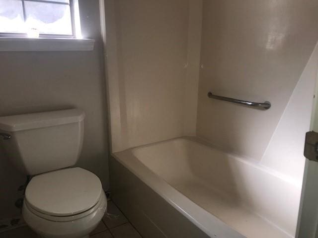 bathroom featuring tile patterned flooring and toilet