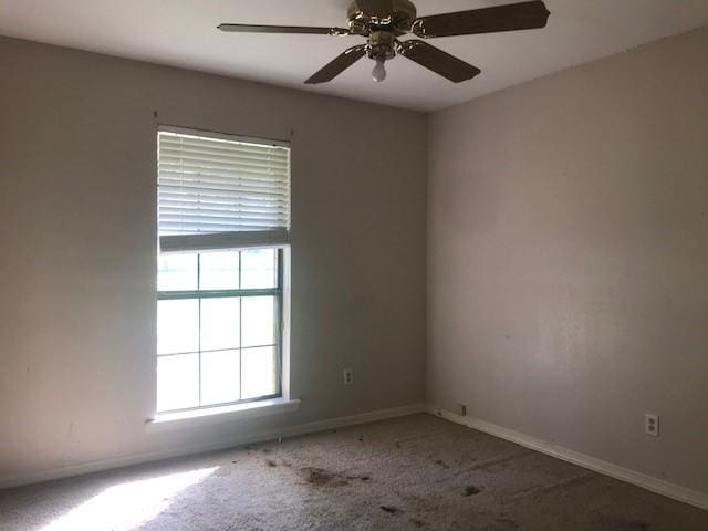 empty room with ceiling fan and carpet flooring