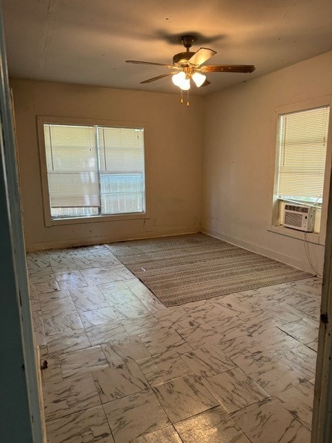 empty room with cooling unit, ceiling fan, and light tile patterned floors