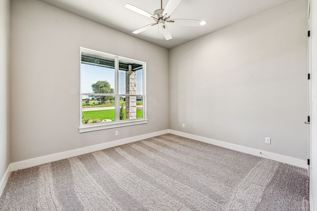 spare room featuring carpet floors and ceiling fan