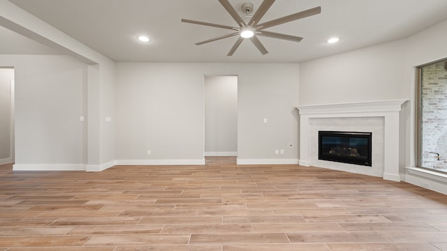 unfurnished living room with ceiling fan and light hardwood / wood-style flooring