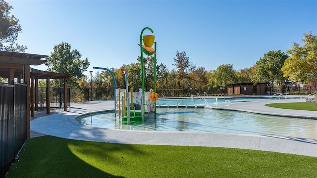 exterior space with pool water feature, a lawn, and a community pool