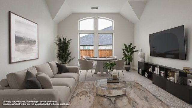 carpeted living room with lofted ceiling