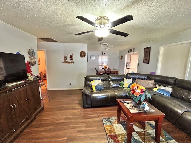 living room with a textured ceiling, ceiling fan, and hardwood / wood-style floors