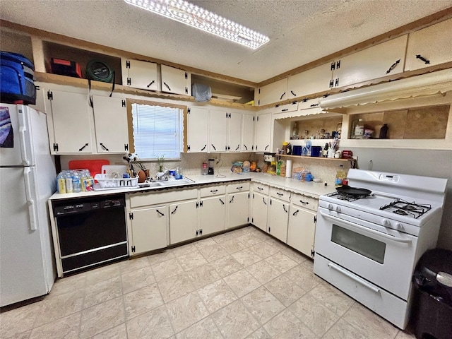 kitchen featuring a textured ceiling, white cabinets, and white appliances