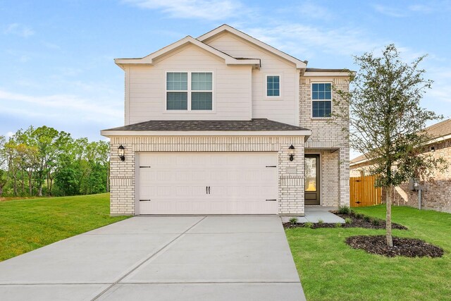 view of property with a garage and a front lawn