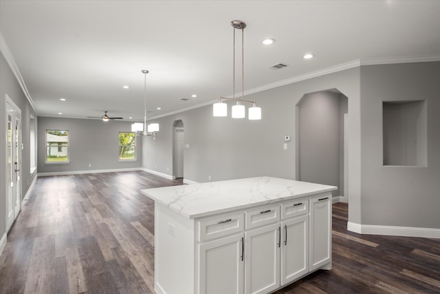 kitchen featuring crown molding, a kitchen island, ceiling fan, pendant lighting, and hardwood / wood-style flooring