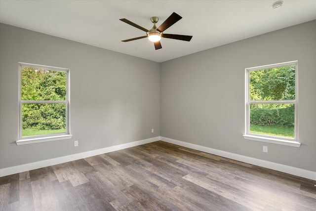 spare room featuring plenty of natural light, ceiling fan, and hardwood / wood-style floors