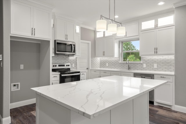 kitchen with decorative backsplash, crown molding, dark hardwood / wood-style floors, and stainless steel appliances