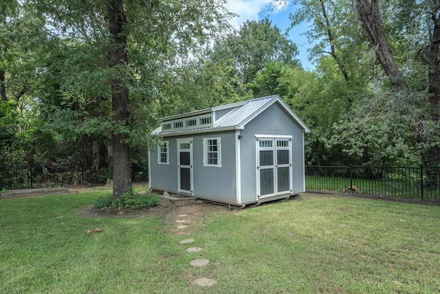 view of outbuilding featuring a lawn