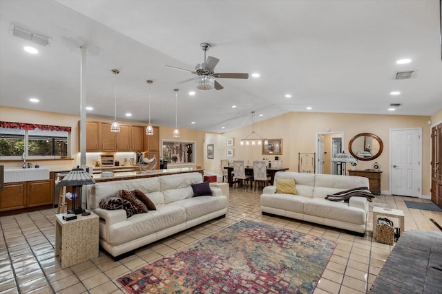 living room featuring vaulted ceiling, sink, light tile patterned floors, and ceiling fan