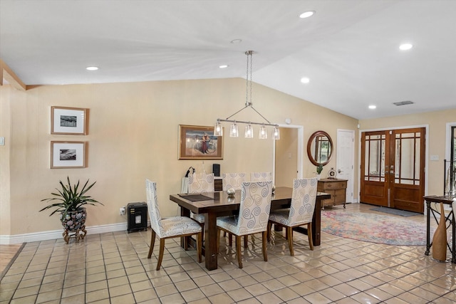 dining room featuring lofted ceiling, light tile patterned floors, and french doors