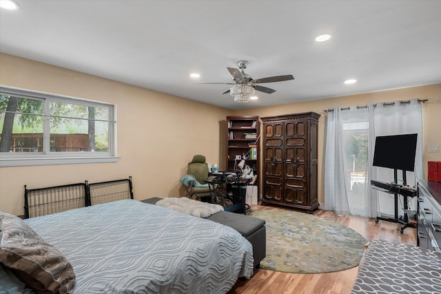 bedroom with ceiling fan, access to exterior, and light wood-type flooring