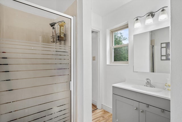 bathroom featuring vanity, hardwood / wood-style floors, and an enclosed shower