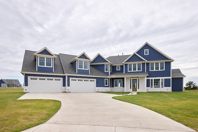 view of front of home featuring a garage and a front lawn