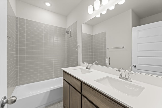 bathroom featuring vanity and tiled shower / bath