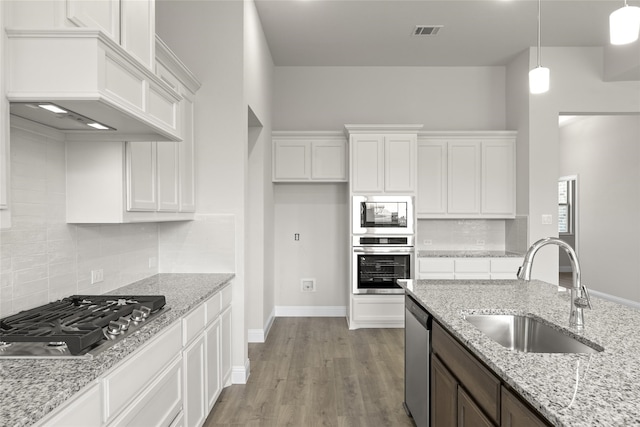 kitchen with white cabinetry, appliances with stainless steel finishes, sink, and light wood-type flooring