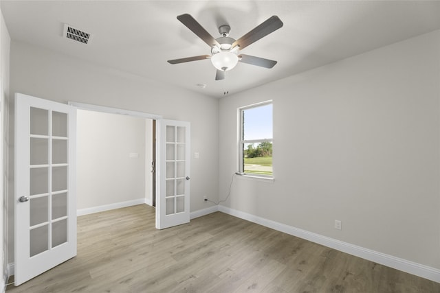 unfurnished room with french doors, ceiling fan, and light hardwood / wood-style flooring