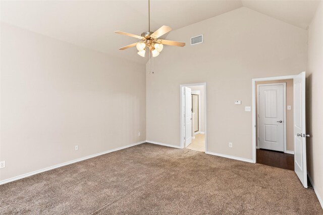 spare room with high vaulted ceiling, ceiling fan, and light colored carpet