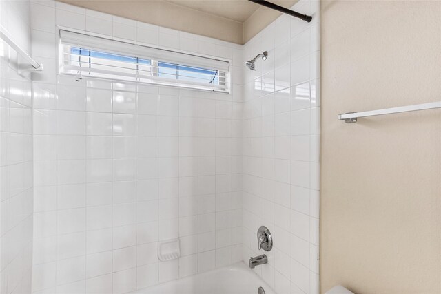 interior details featuring tiled shower / bath