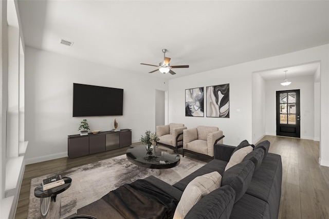 living room featuring ceiling fan and hardwood / wood-style floors