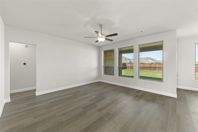 kitchen featuring oven, hanging light fixtures, light hardwood / wood-style flooring, black microwave, and a kitchen island with sink