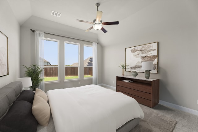 bedroom featuring light carpet, lofted ceiling, and ceiling fan