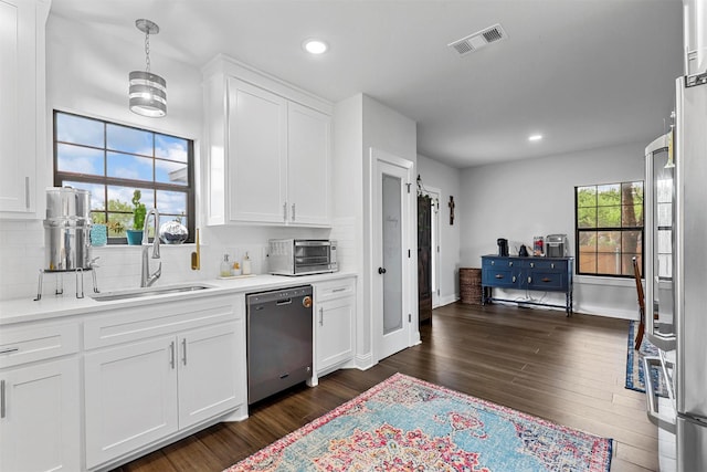 kitchen featuring white cabinetry, dishwashing machine, and sink