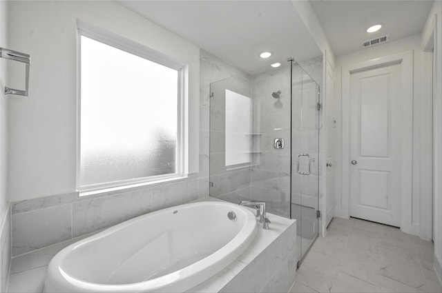 bathroom featuring plus walk in shower