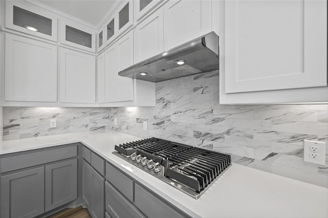 kitchen with gray cabinets, white cabinetry, tasteful backsplash, and ventilation hood