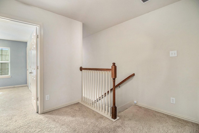 stairway featuring carpet and baseboards