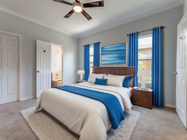 bedroom with ceiling fan, ornamental molding, ensuite bath, and light carpet