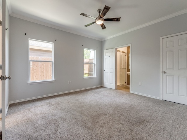 unfurnished bedroom with ceiling fan, crown molding, connected bathroom, and light carpet