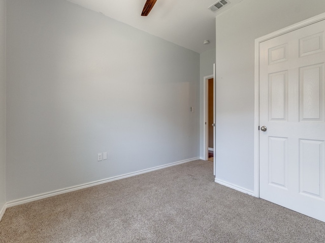 unfurnished bedroom featuring ceiling fan and light colored carpet