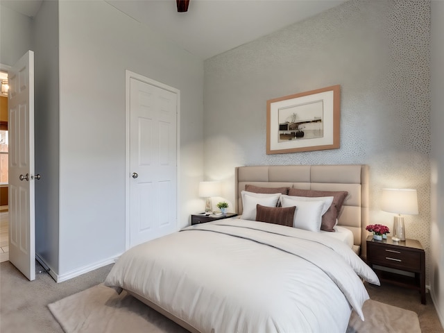 bedroom featuring ceiling fan and light carpet