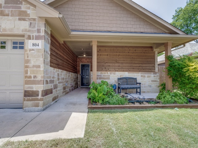 doorway to property featuring a garage and a yard