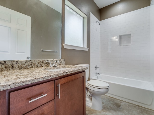 full bathroom featuring tiled shower / bath, toilet, tile patterned floors, and vanity