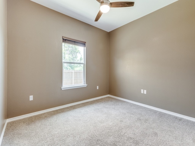 empty room with carpet flooring and ceiling fan