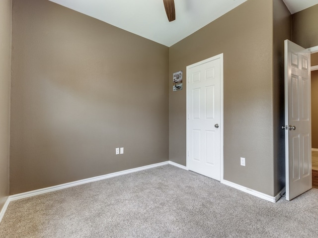 carpeted empty room featuring ceiling fan