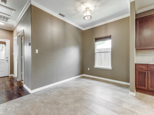 unfurnished dining area featuring light hardwood / wood-style floors and crown molding