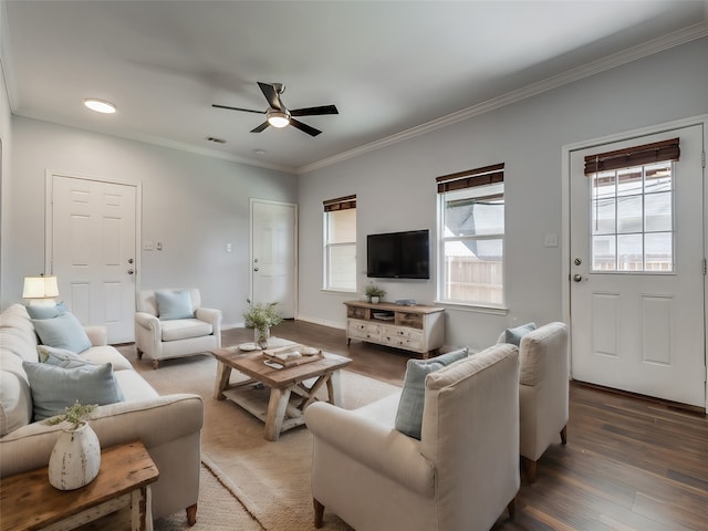 living room featuring ceiling fan, a healthy amount of sunlight, dark hardwood / wood-style flooring, and crown molding